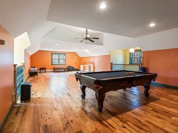a view of a room with wooden floor and furniture