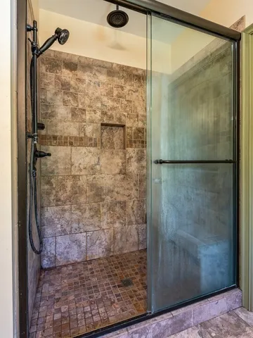 a bathroom with a glass shower door