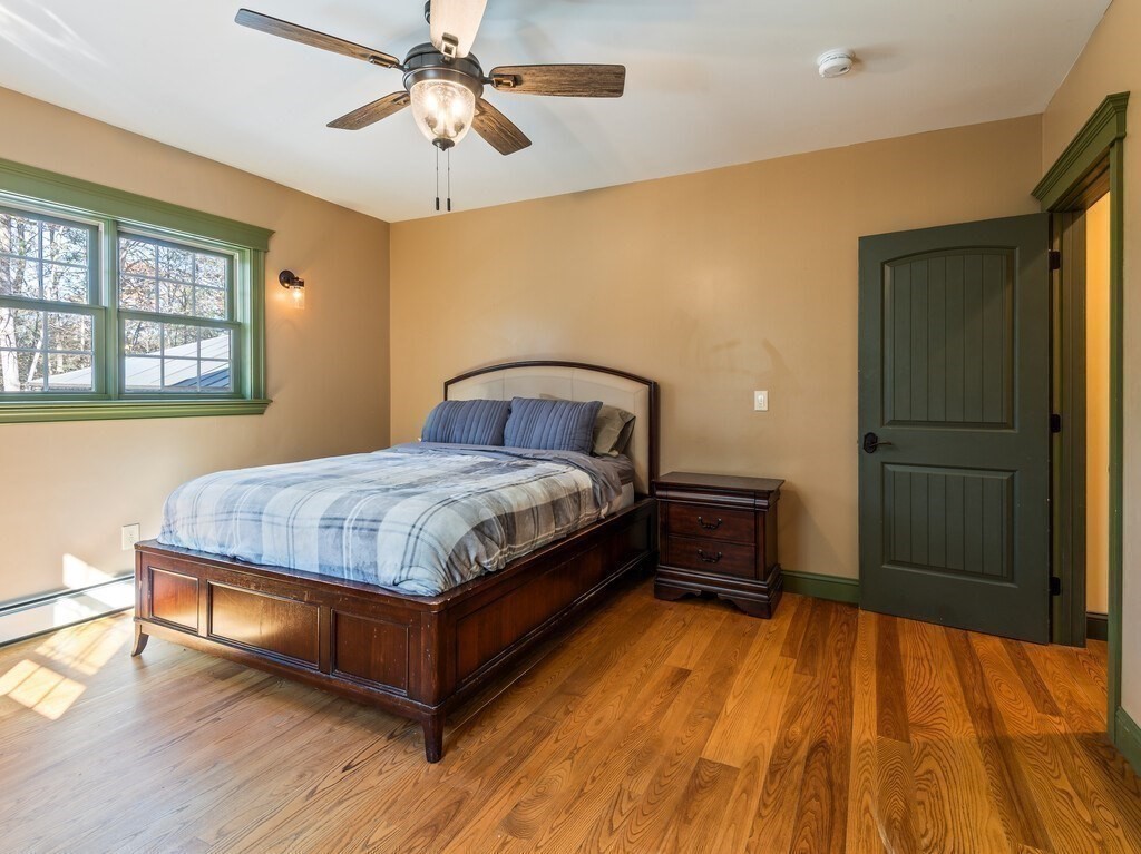1082 Old Dana Road Barre, MA 01005 - Photo 28 of 42 a bedroom with a bed and a chandelier