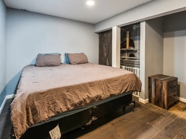 a bed sitting in a bedroom next to a window