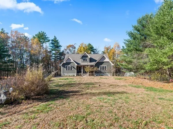 a yellow house with trees in front of it