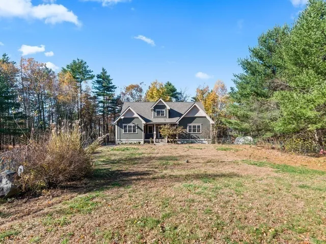 a yellow house with trees in front of it