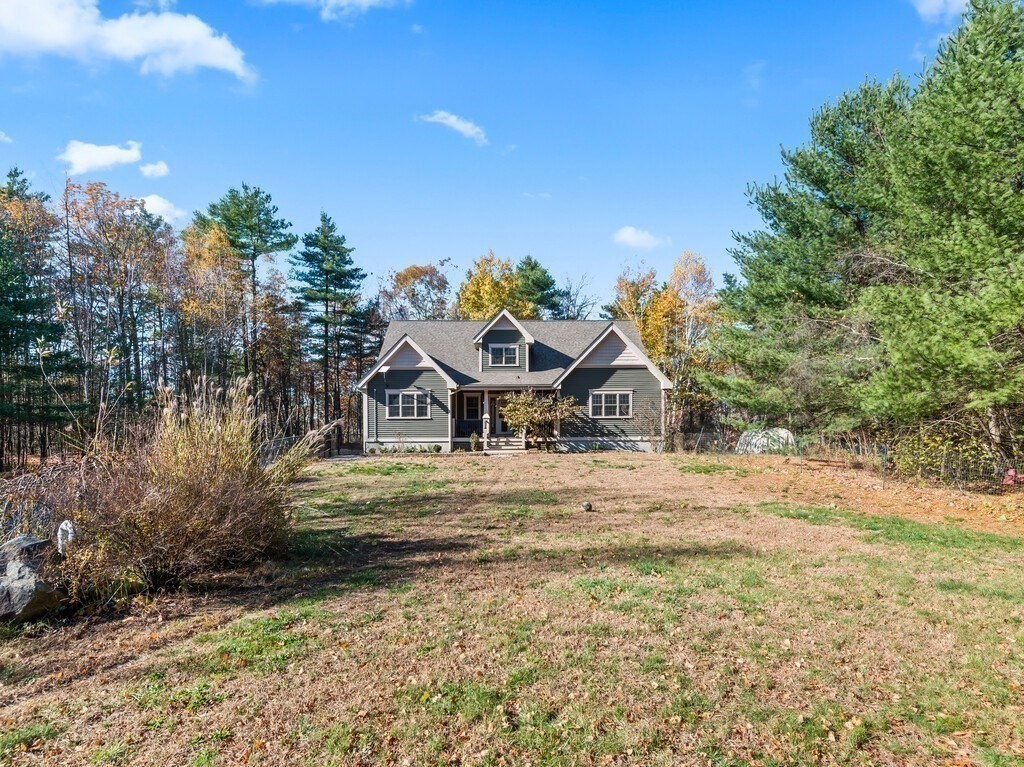 1082 Old Dana Road Barre, MA 01005 - Photo 39 of 42 a yellow house with trees in front of it