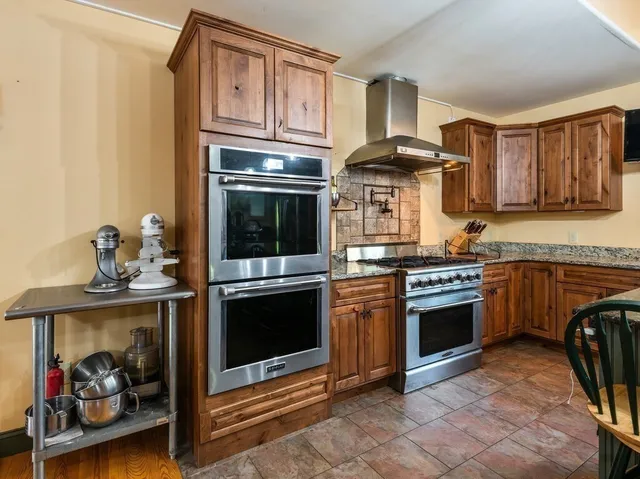 a kitchen with granite countertop a stove and a sink