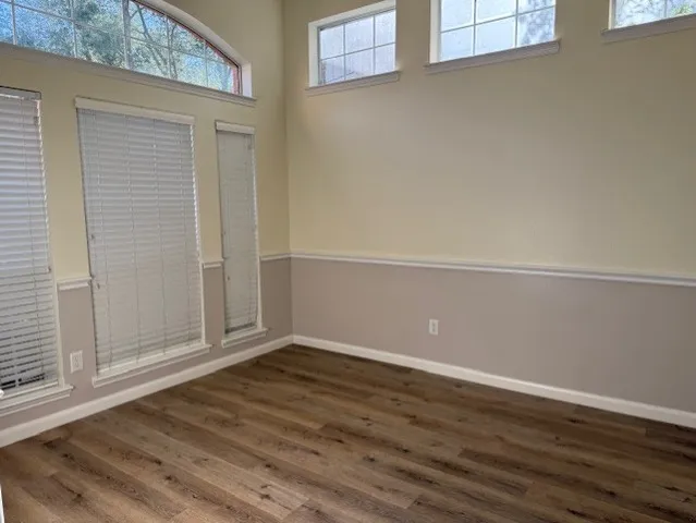 an empty room with wooden floor