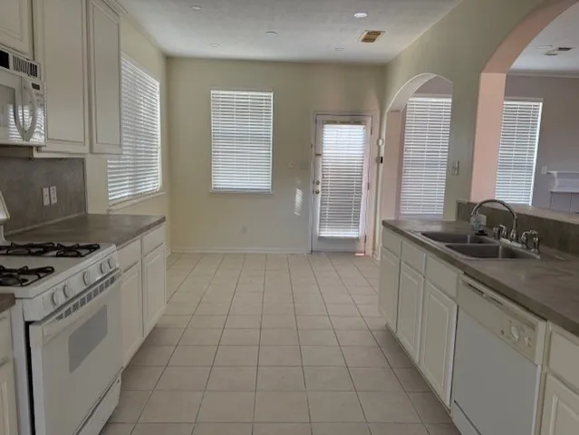 a kitchen with a sink stove and cabinets