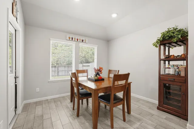 a view of a dining room with furniture and a potted plant