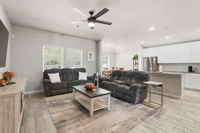 a living room with furniture and a large window