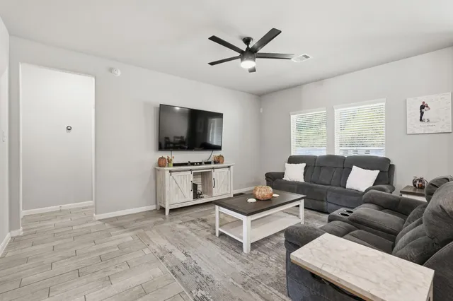 a living room with furniture and a flat screen tv