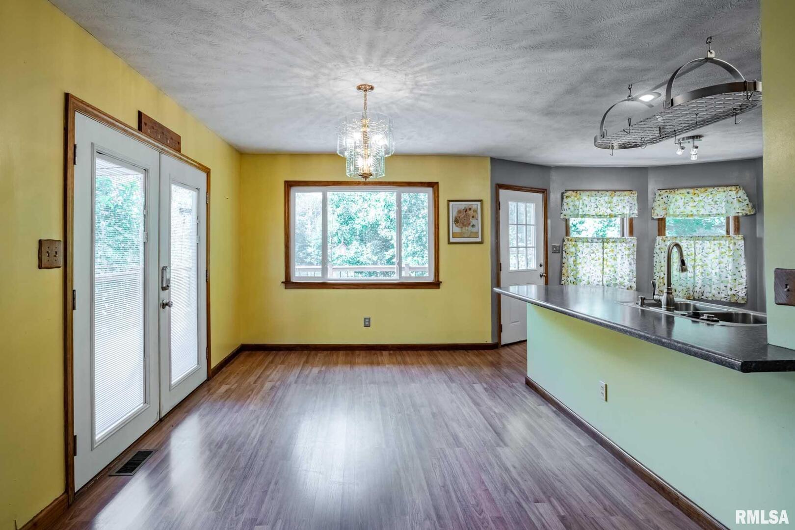 541 Dallas Road Murphysboro, IL 62966 - Photo 23 of 78 a view of a room with window wooden floor and chandelier