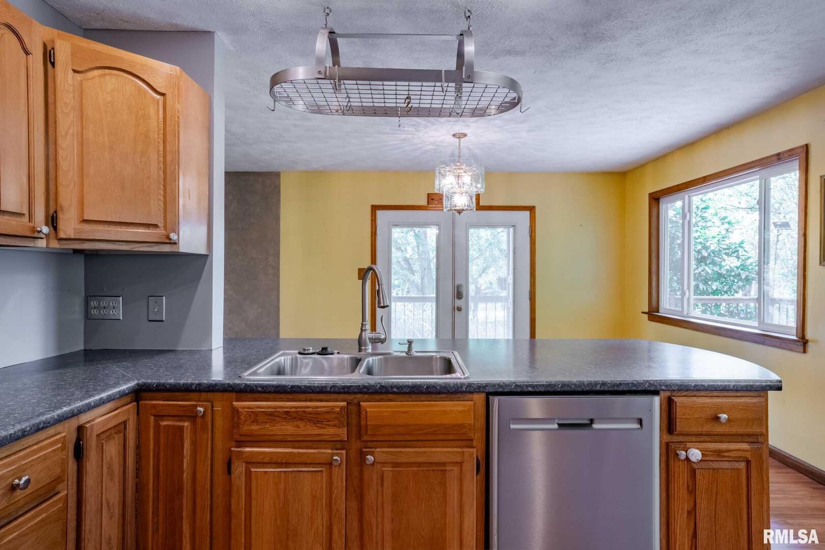 541 Dallas Road Murphysboro, IL 62966 - Photo 27 of 78 a kitchen with stainless steel appliances granite countertop wooden cabinets a sink a stove and a wooden floor
