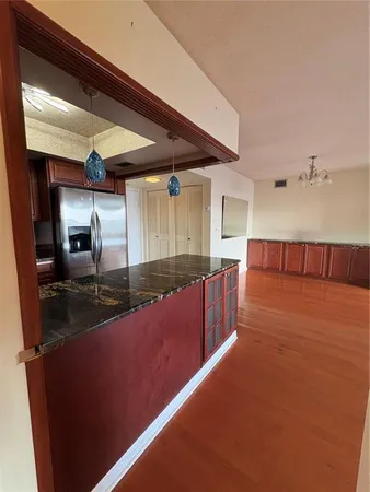 a view of a room with wooden floor