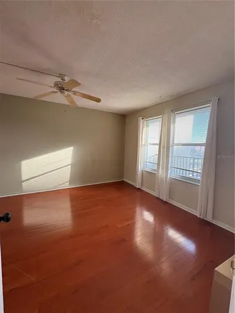 an empty room with windows and closet