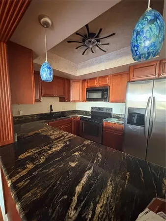 a kitchen with stainless steel appliances granite countertop a sink and a stove