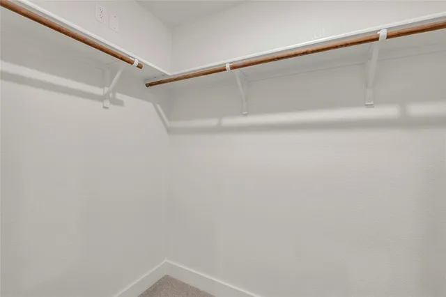 a bathroom with a granite countertop sink and mirror with bathtub