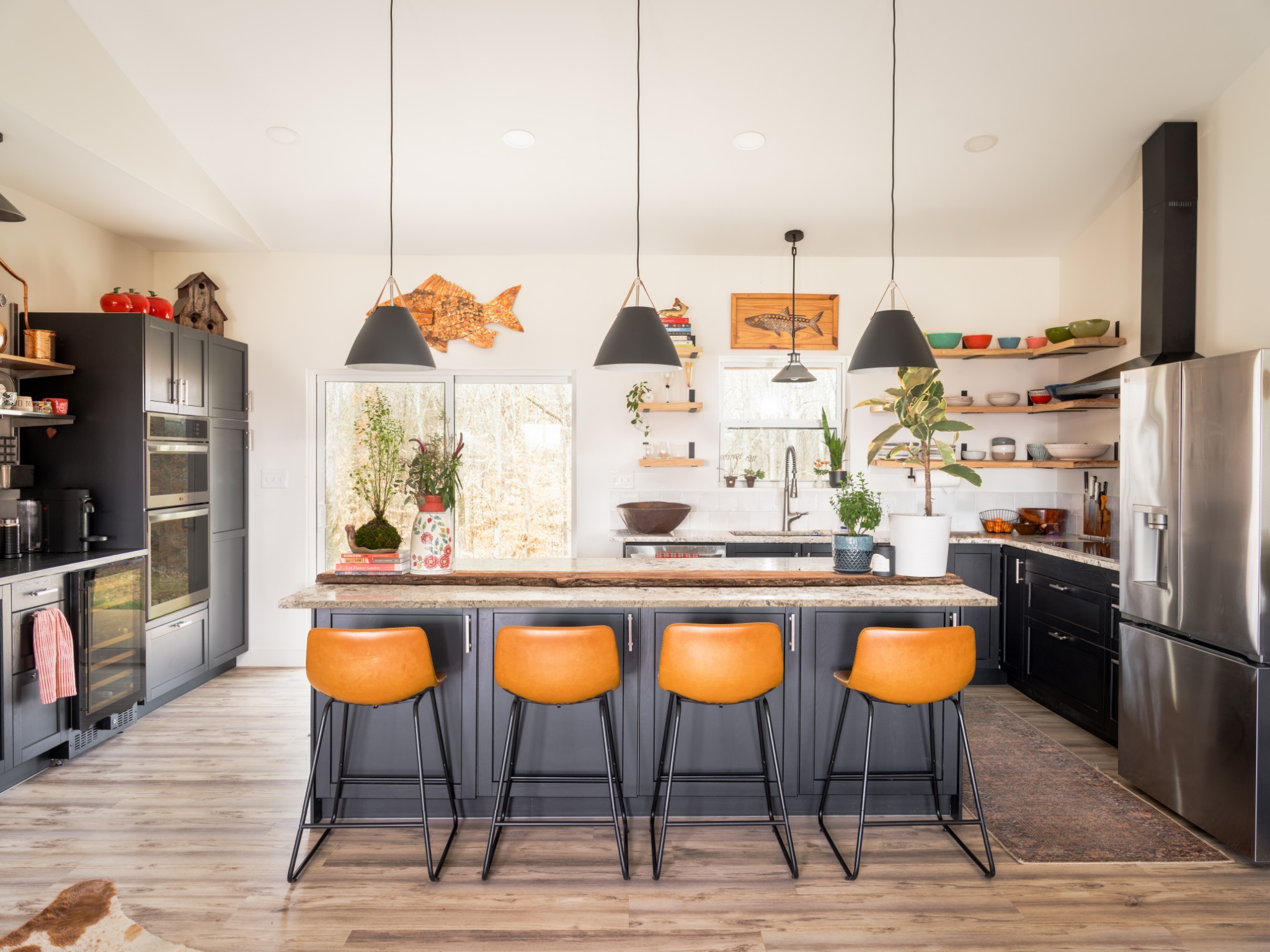 7050 Bakerville Road Waverly, TN 37185 - Photo 15 of 50 a kitchen with stainless steel appliances kitchen island granite countertop a table chairs in it and wooden floors
