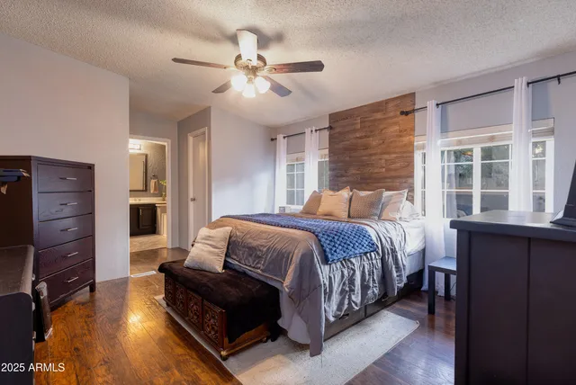 a bedroom with a bed and wooden floor
