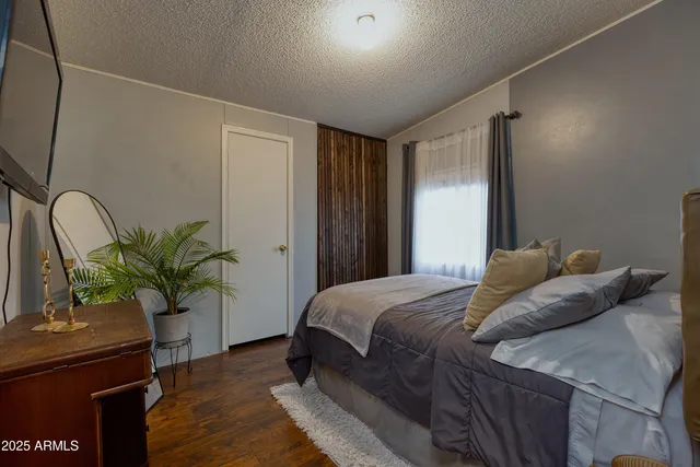 a bedroom with a bed and a potted plant