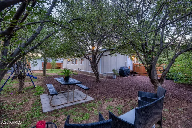 a view of a backyard with sitting area