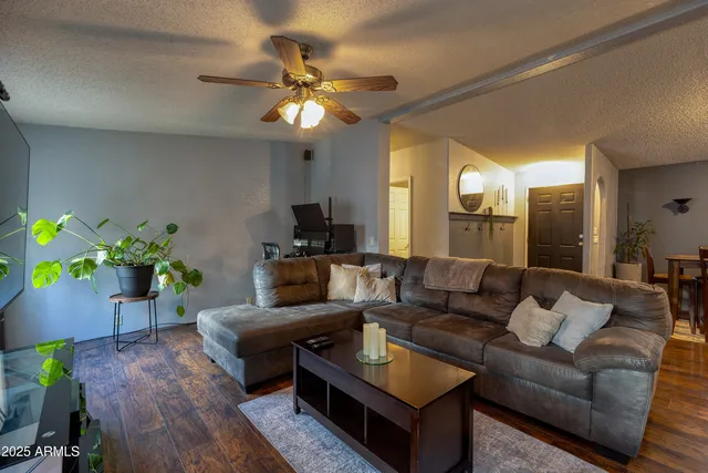 a living room with furniture and a wooden floor
