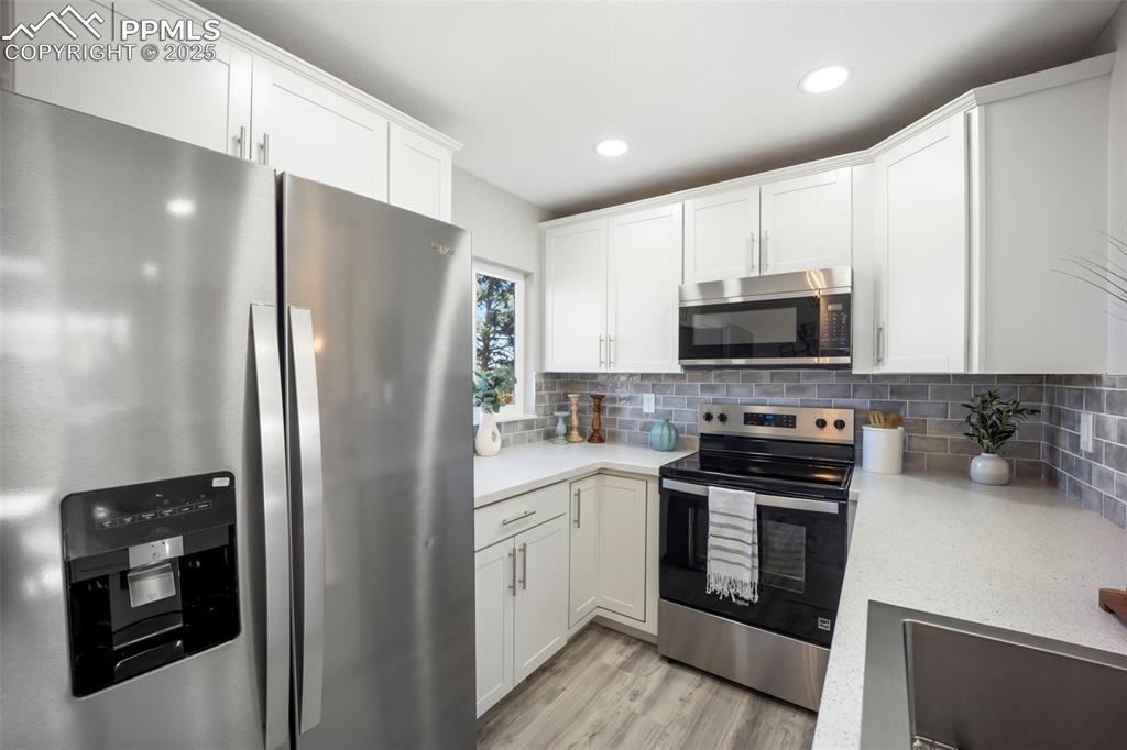 2010 Hampton South Colorado Springs, CO 80906 - Photo 17 of 45 a kitchen with a refrigerator and a stove top oven