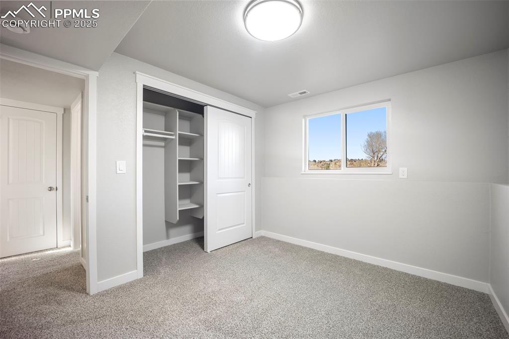 2010 Hampton South Colorado Springs, CO 80906 - Photo 28 of 45 an empty room with closet and windows