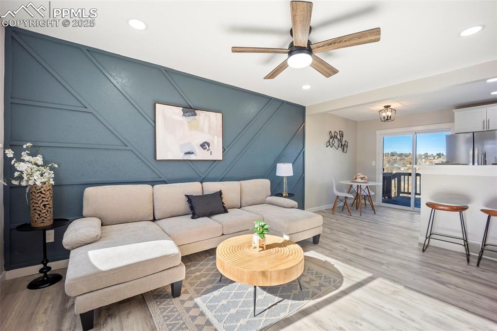 2010 Hampton South Colorado Springs, CO 80906 - Photo 10 of 45 a living room with furniture a dining table and a fireplace