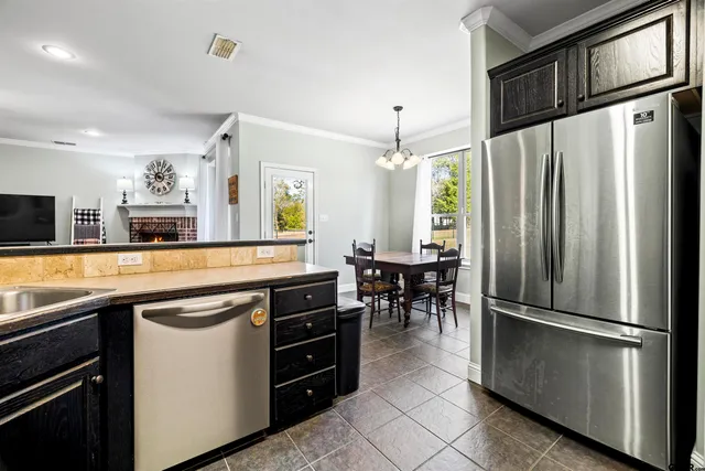 a kitchen with stainless steel appliances a refrigerator a stove a sink and a refrigerator