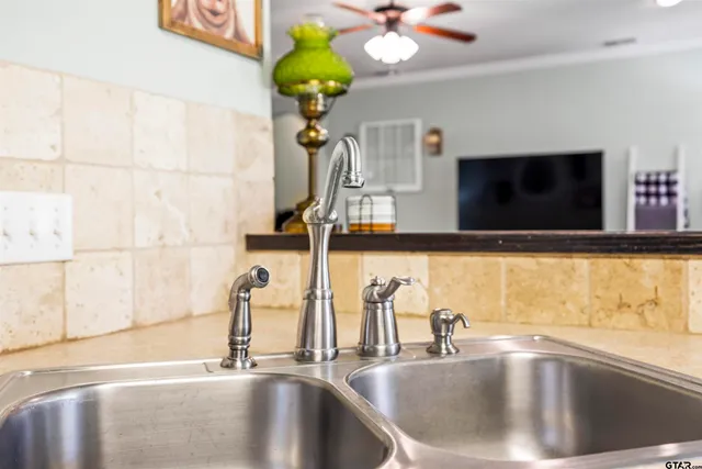 a kitchen with a faucet a sink and a window