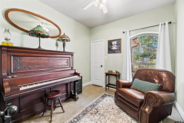 a living room with furniture a chandelier and a window