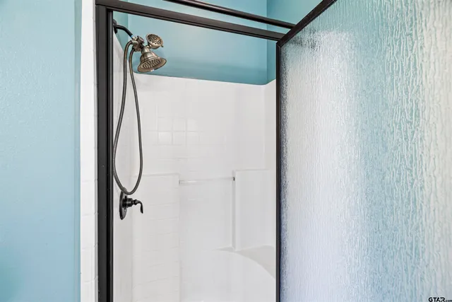 a bathroom with a double vanity sink mirror and toilet