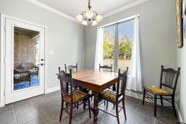 a living room with furniture a chandelier and a window