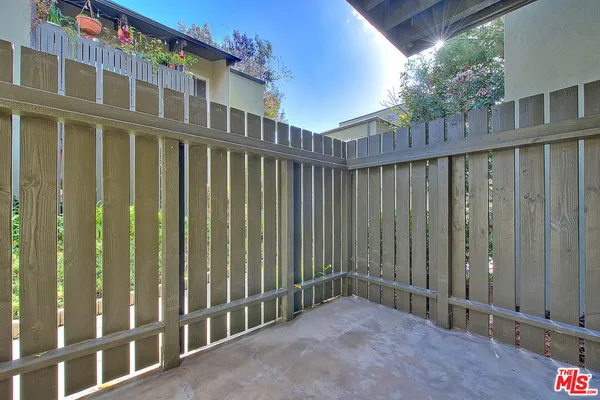 a view of a house with wooden fence