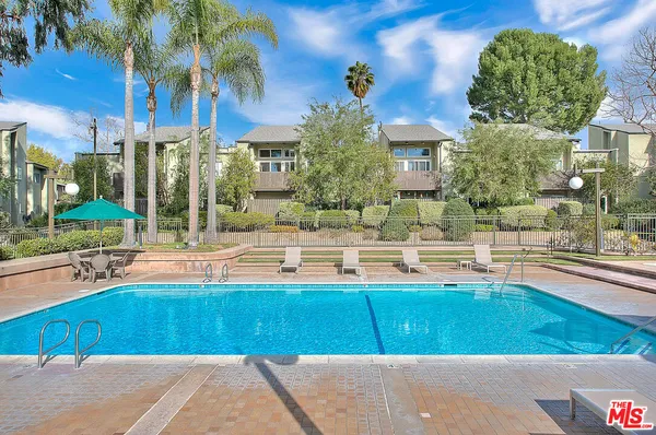 a view of a swimming pool with a lounge chairs