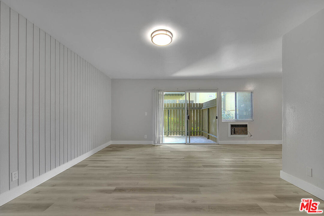 4822 Hollow Corner Road, Unit 177 Culver City, CA 90230 - Photo 6 of 39 a view of an empty room with wooden floor and a window
