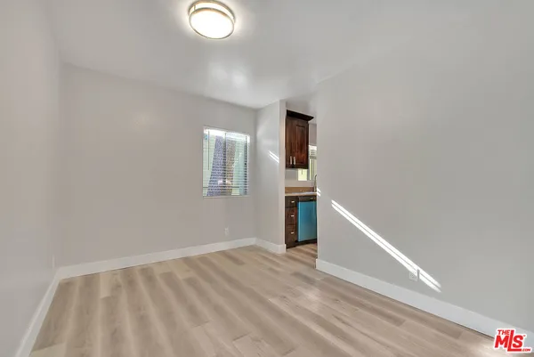 a view of empty room with wooden floor