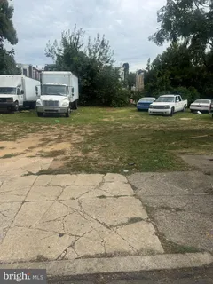 a view of a lake with lawn chairs under an umbrella