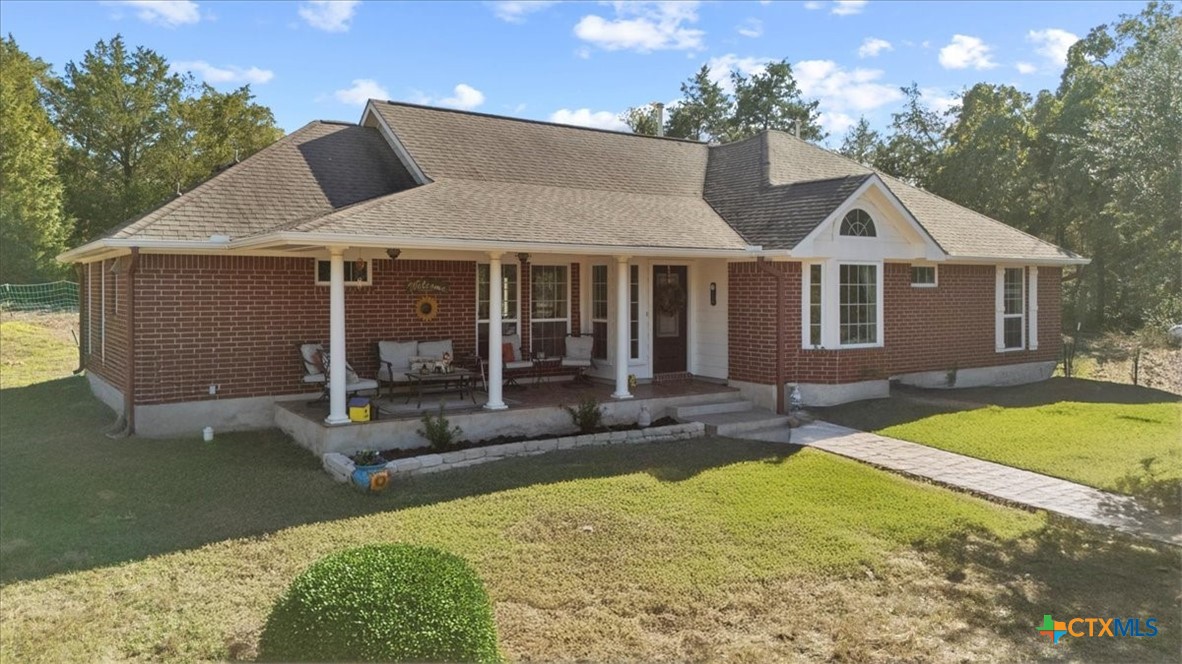 a front view of a house with a yard and porch