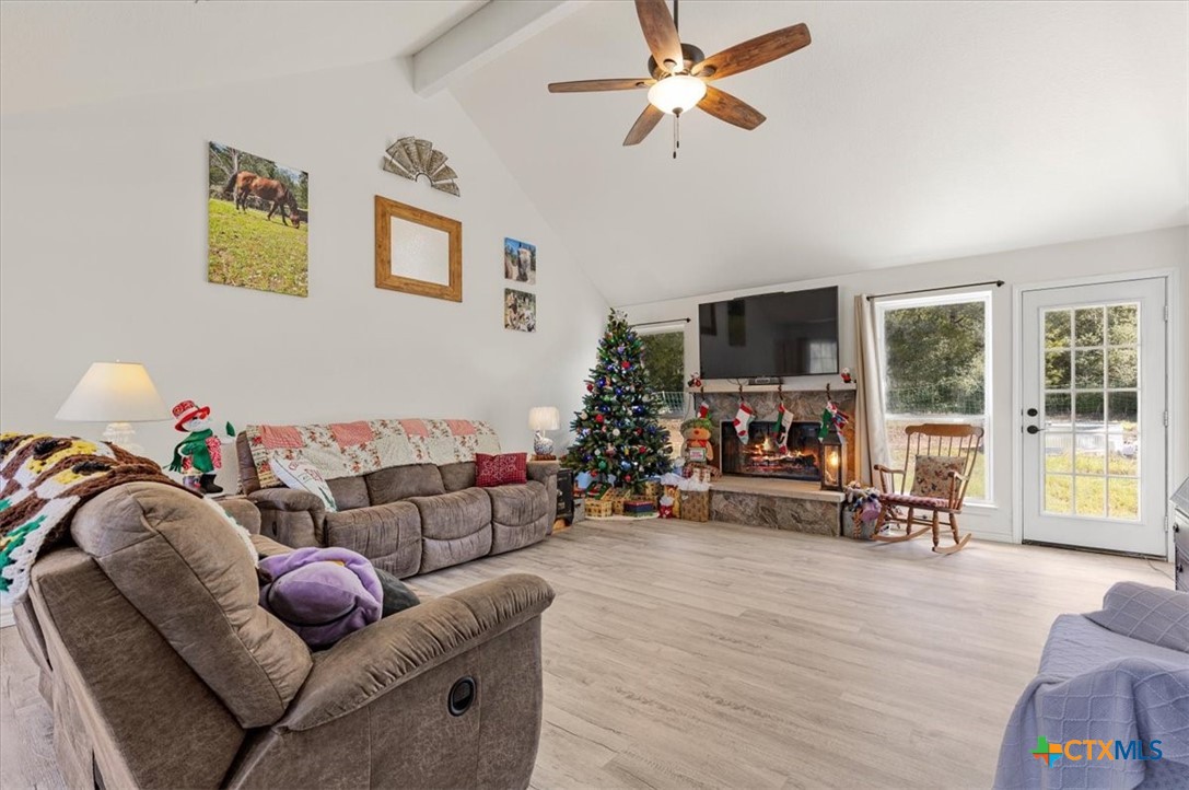 110 Sky Ranch Road Smithville, TX 78957 - Photo 11 of 31 a living room with furniture and a flat screen tv with wooden floor