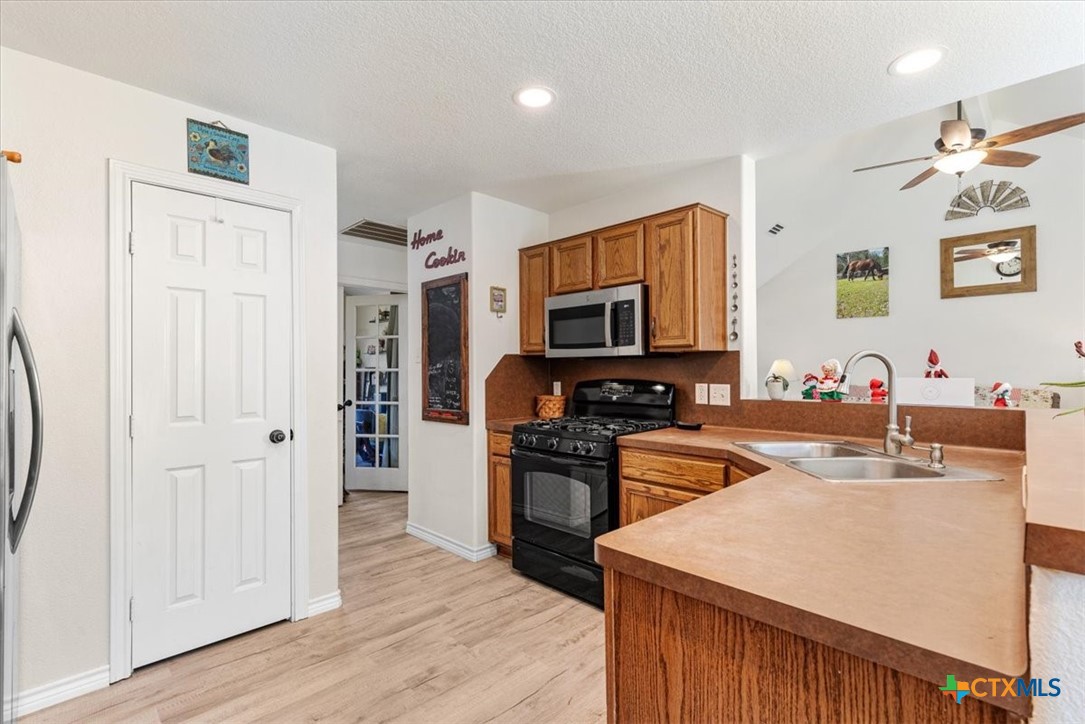 110 Sky Ranch Road Smithville, TX 78957 - Photo 14 of 31 a kitchen with stainless steel appliances granite countertop a sink stove and refrigerator