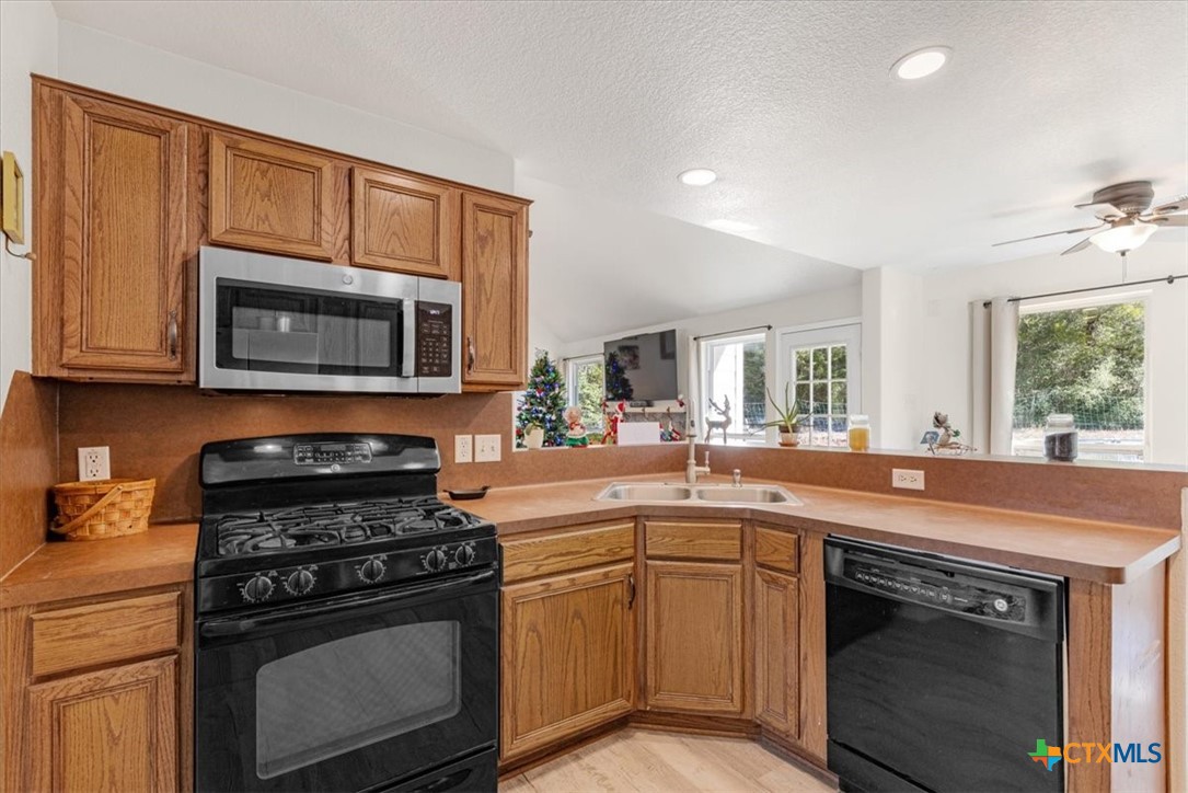 110 Sky Ranch Road Smithville, TX 78957 - Photo 15 of 31 a kitchen with a stove and a microwave