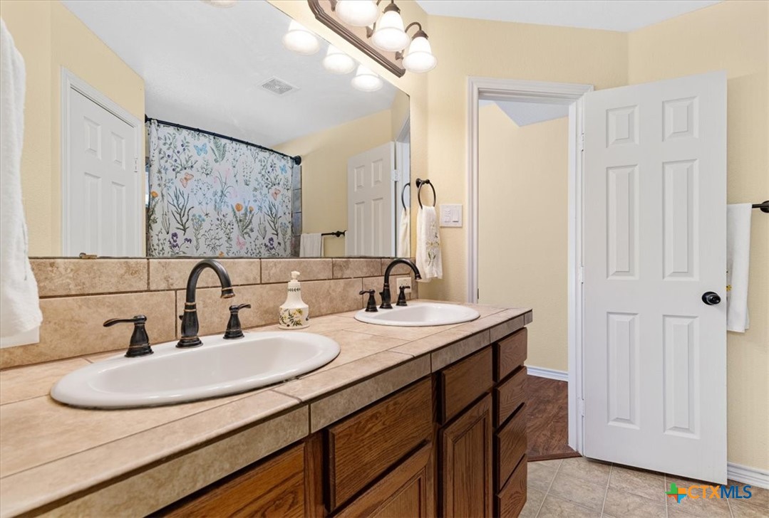 110 Sky Ranch Road Smithville, TX 78957 - Photo 18 of 31 a bathroom with a sink and a mirror