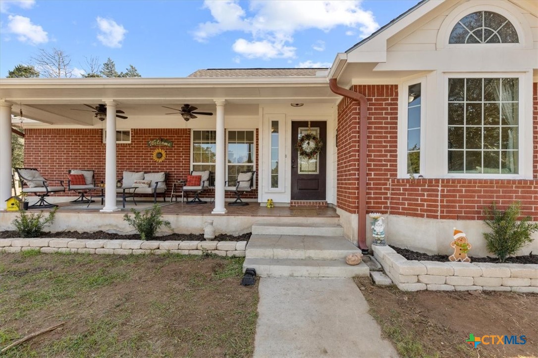 110 Sky Ranch Road Smithville, TX 78957 - Photo 8 of 31 a front view of a house with outdoor seating and plants