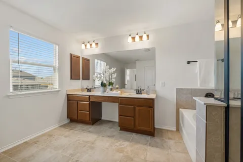 a bathroom with a sink a vanity and a mirror