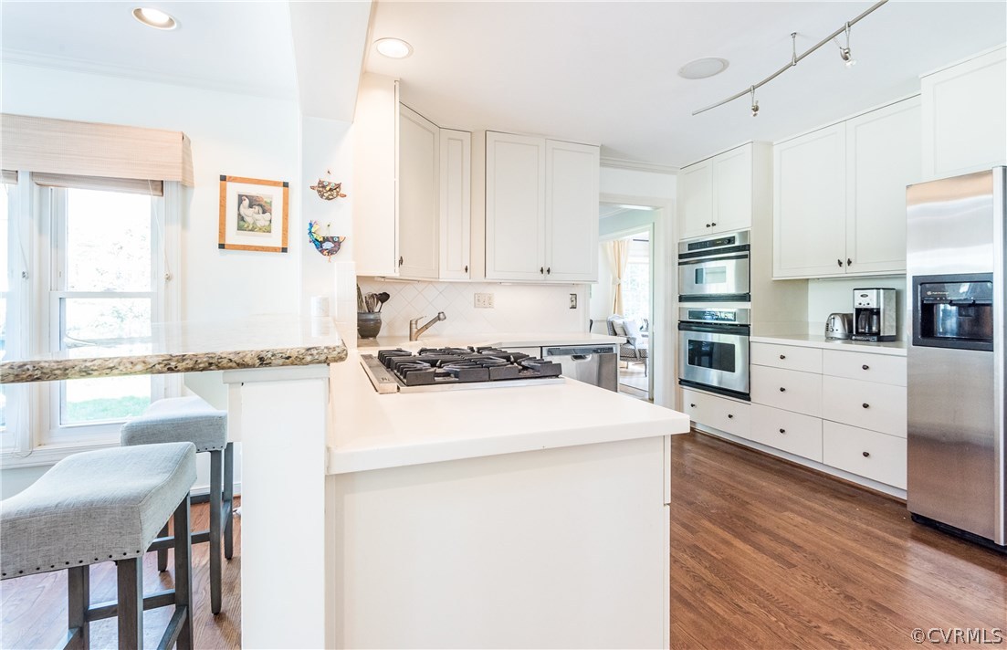 108 Ralston Road Henrico, VA 23229 - Photo 10 of 42 a kitchen with granite countertop a sink a stove a dining table and chairs