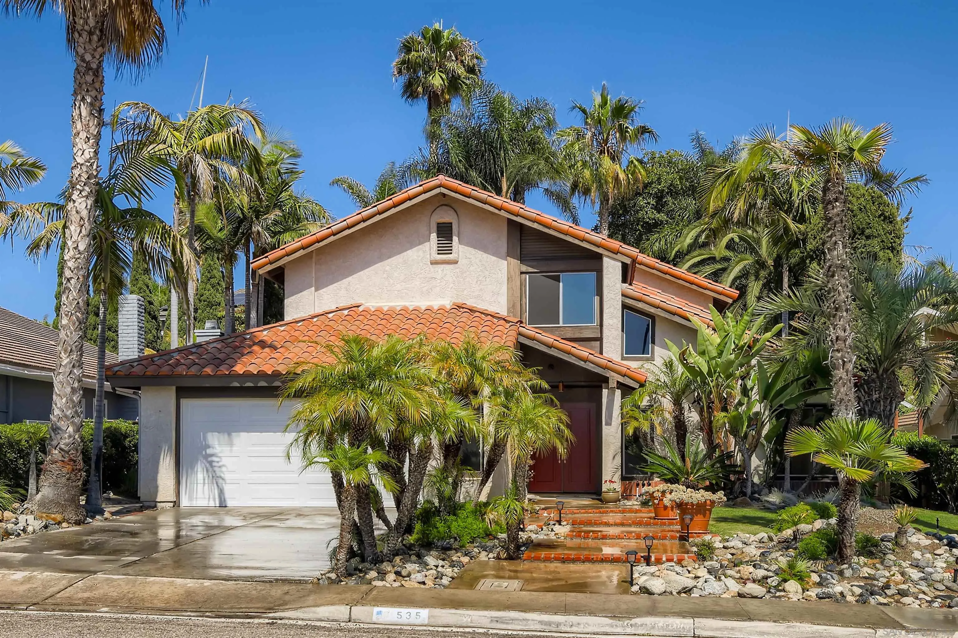 a front view of a house with garden