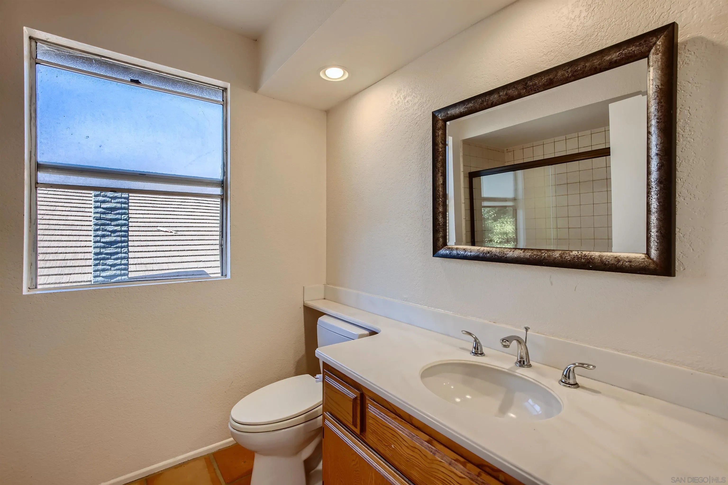 535 Gardendale Road Encinitas, CA 92024 - Photo 19 of 23 a bathroom with a toilet a sink and mirror