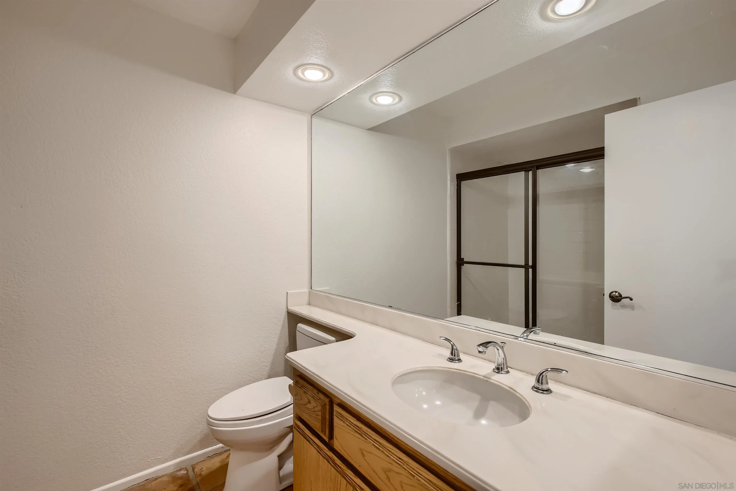 535 Gardendale Road Encinitas, CA 92024 - Photo 20 of 23 a bathroom with a sink toilet and mirror