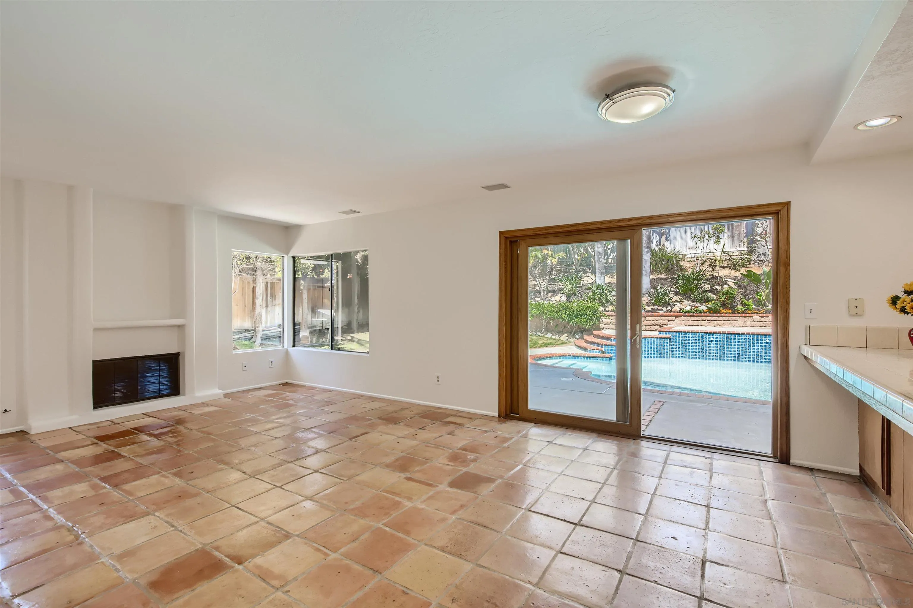 535 Gardendale Road Encinitas, CA 92024 - Photo 3 of 23 a view of an empty room with a fireplace and a window