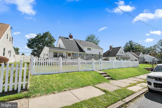 a view of a house with a yard and porch